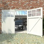 Cream painted timber garage doors open with a car parked inside